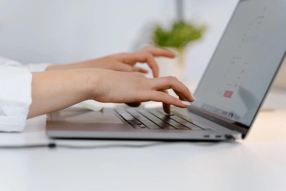 A man drawing a business strategy graph in a notebook indoors.
